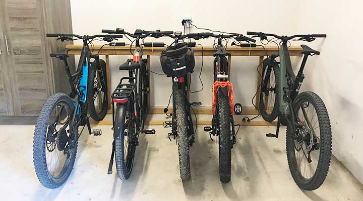 custom made wood bike rack for electronic bikes in garage